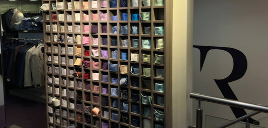 The tie and pocket square wall at Ryle Menswear, Tralee - dozens of colours arranged by shade