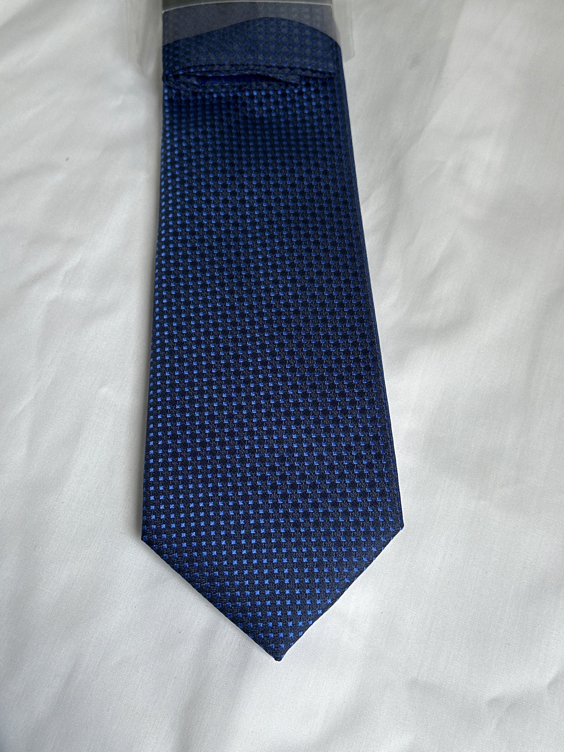 Dark blue micro-square tie and matching pocket square at Ryle Menswear, Tralee