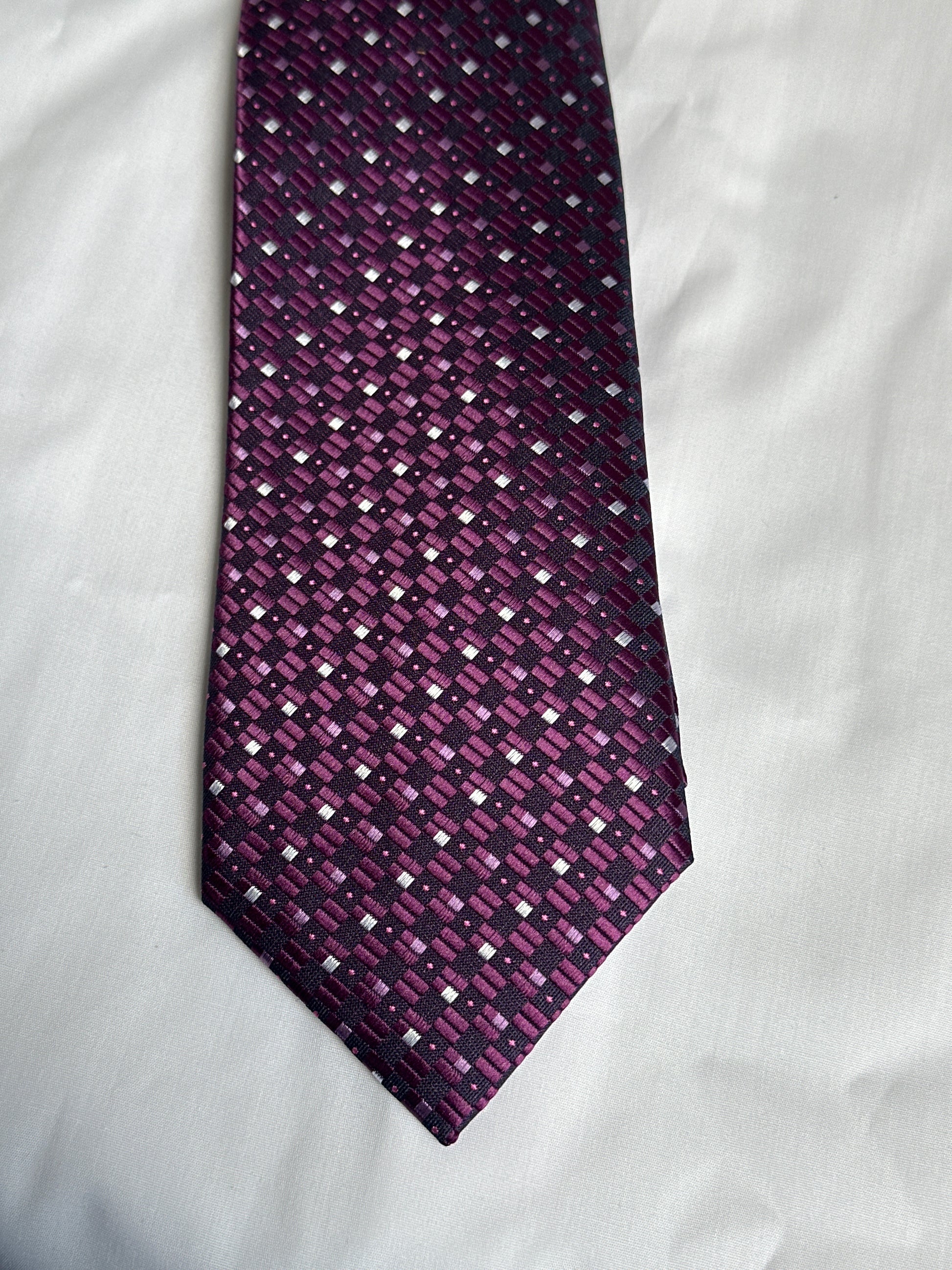 Purple geometric tie and matching pocket square at Ryle Menswear, Tralee