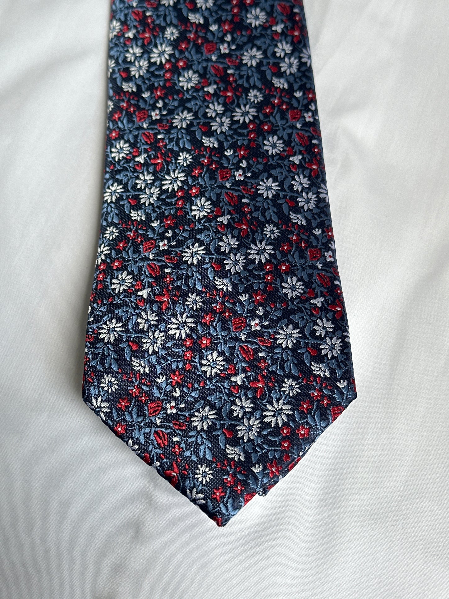 Navy tie with white and red flowers on green stems, with matching pocket square — Ryle Menswear, Tralee
